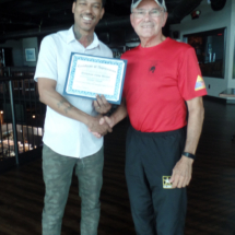 A certificate of appreciation is delivered to Elevation Chop House