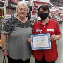 A Certificate of Appreciation is delivered to Sara Koger of Tractor Supply