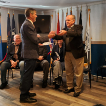 Jake Cave presents Judge Roy Lantz with a Certificate of Appreciation