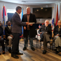 Jake Cave presents Judge Mike Pniewski with a Certificate of Appreciation