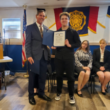 Jake Cave presents Aiden Cumberland with a runner-up certificate